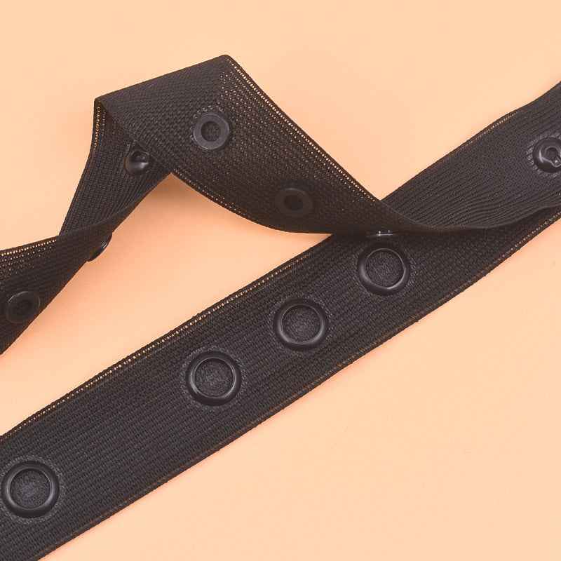 Black sewing snap fastener tape strip with round snap buttons for spaced closures