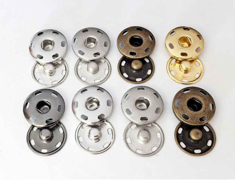 Assorted snap buttons with 4-hole metal faces in silver, black, bronze, and gold
