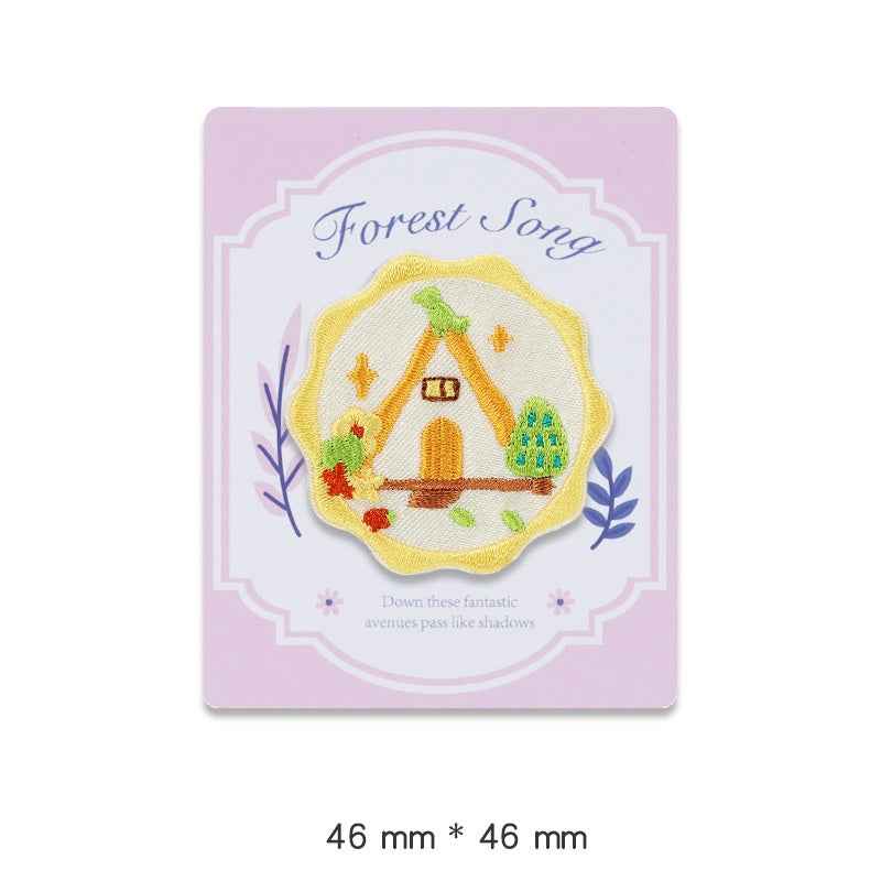 Forest Song embroidered adhesive patch: yellow scalloped circle with birdhouse and plants