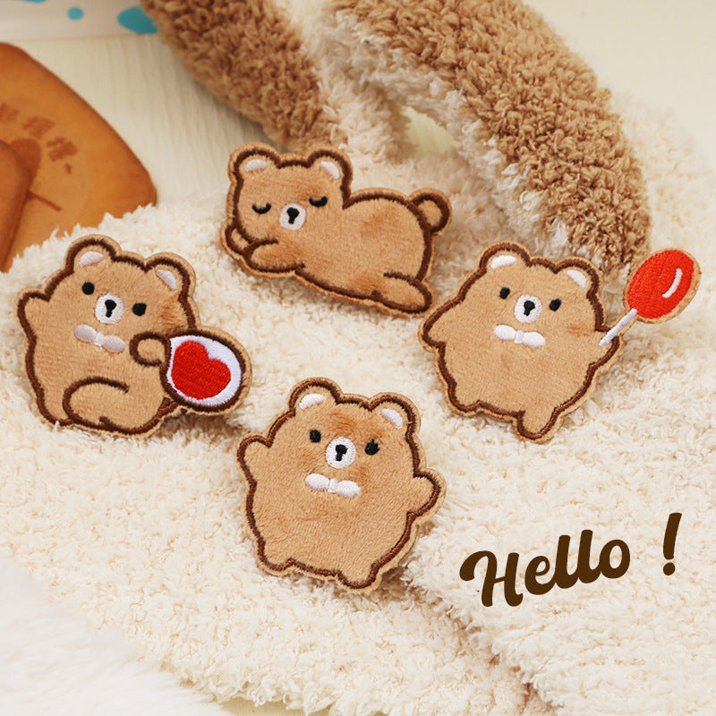 Tan plush bear embroidered self-adhesive patches on cream fuzzy fabric, heart included