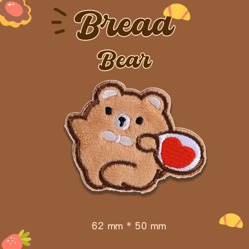 Tan plush bear embroidered patch holding a red heart, 62 mm x 50 mm