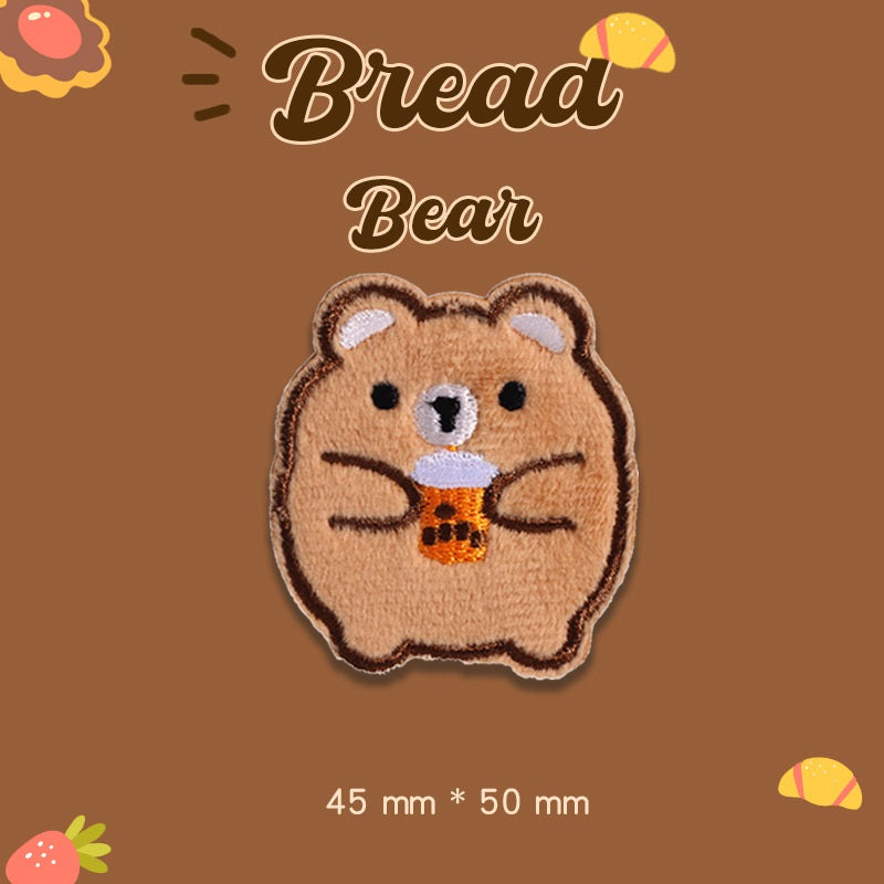 Tan plush bear embroidered patch with orange center detail, 45 mm x 50 mm