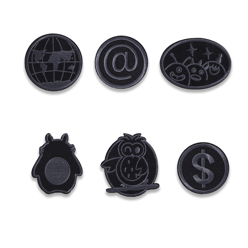 Set of black embroidered circular badge patches: globe, @ sign, and smiling crab design