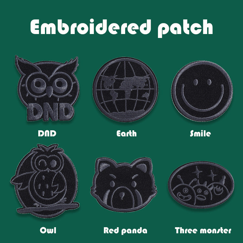 Black embroidered badge patches with owl, globe Earth, smile, Totoro, red panda, and three monsters