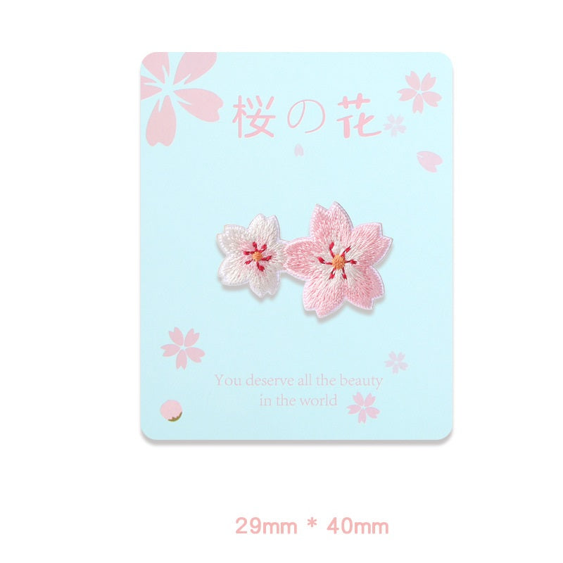 Two-tone pink and white flower embroidered self-adhesive patches with red centers