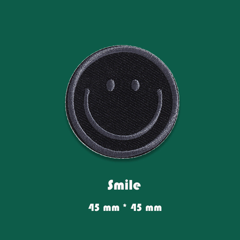 Round black embroidered smiley face badge patch, 45mm x 45mm