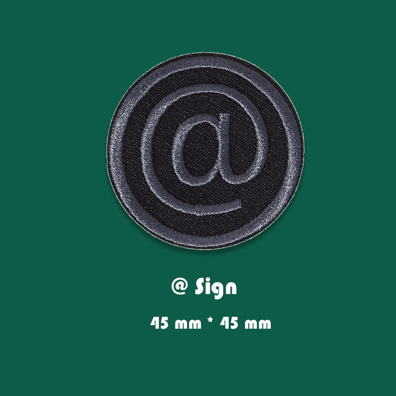 Black embroidered circular @ sign badge patch with raised stitched border