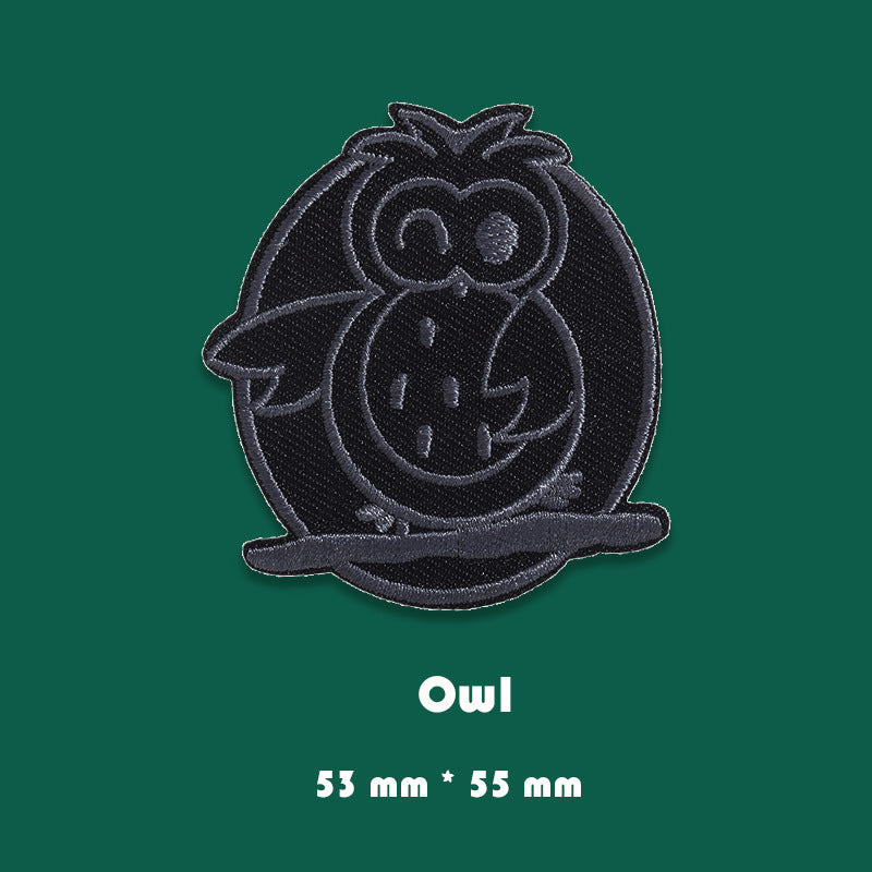 Black embroidered owl badge patch with detailed owl face and outlined stitching
