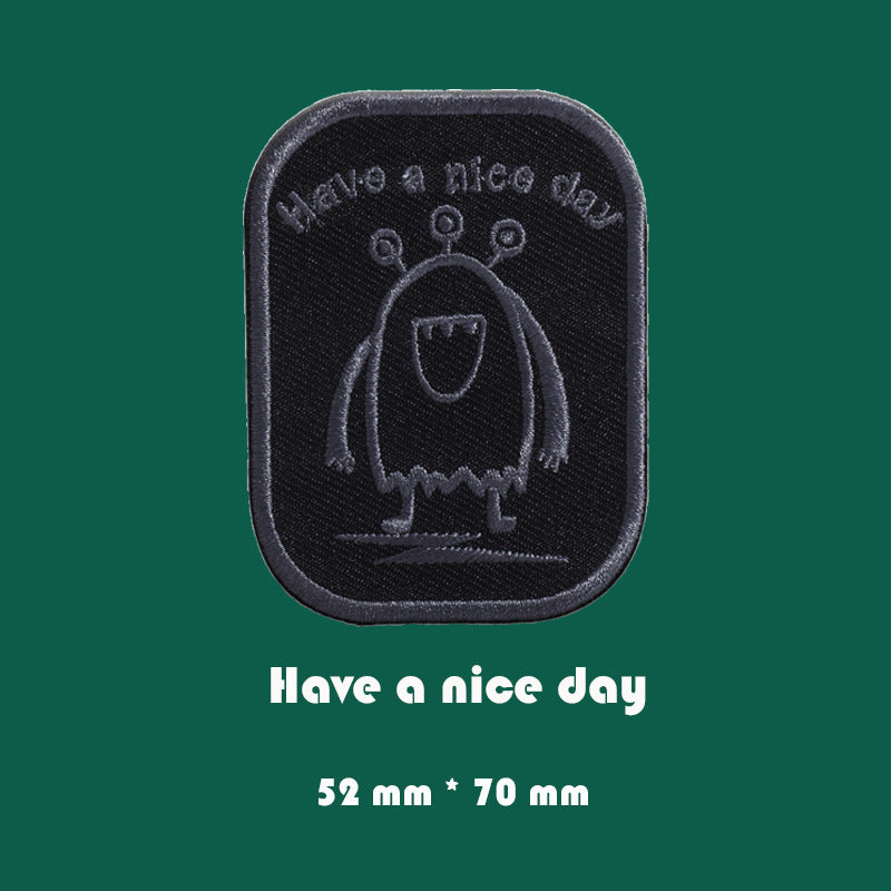 Black embroidered badge patch with penguin-like character, 52mm x 70mm