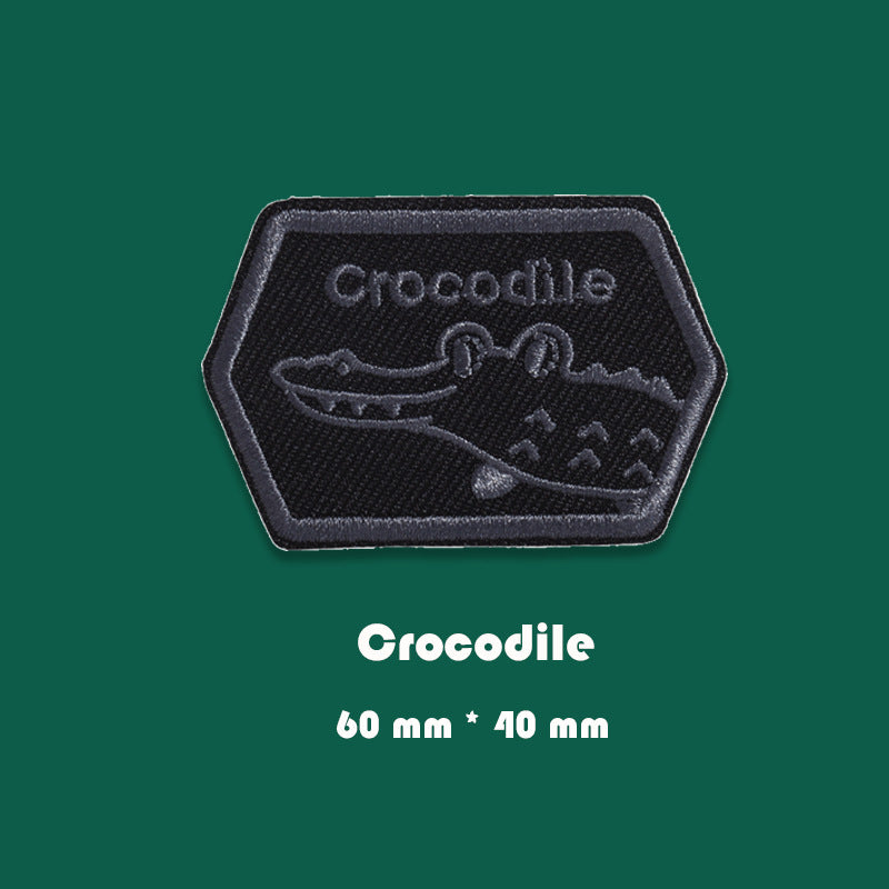 Black embroidered badge patch with crocodile outline, 60mm x 40mm
