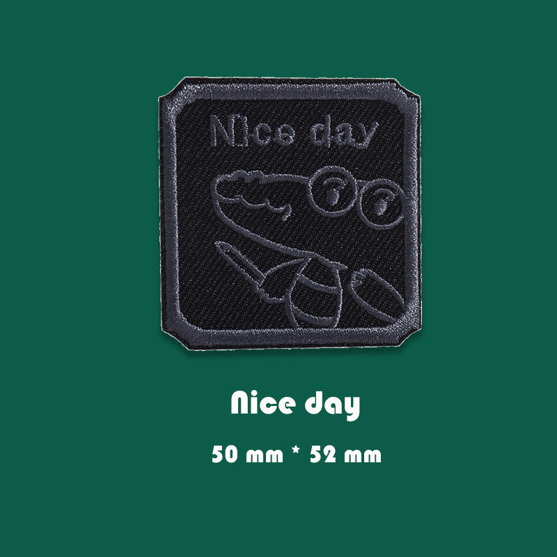 Black embroidered badge patch with “Nice day” text and cartoon character, 50mm x 52mm