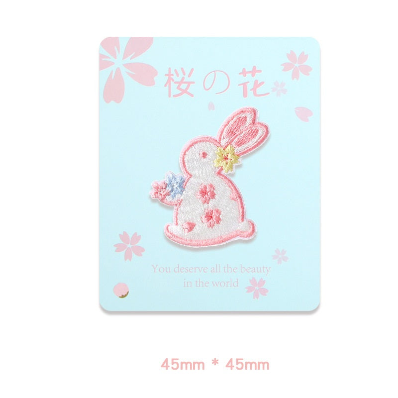 Pink rabbit embroidered self-adhesive patch with blue paw flower and pink blossoms