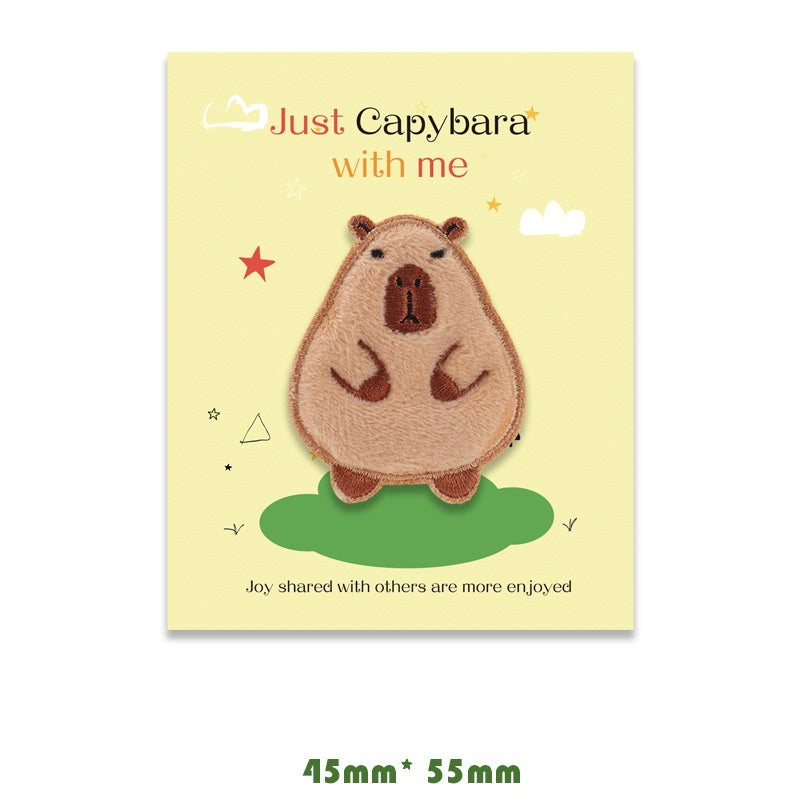 Brown and tan capybara embroidered self-adhesive patch, front pose with arms resting.