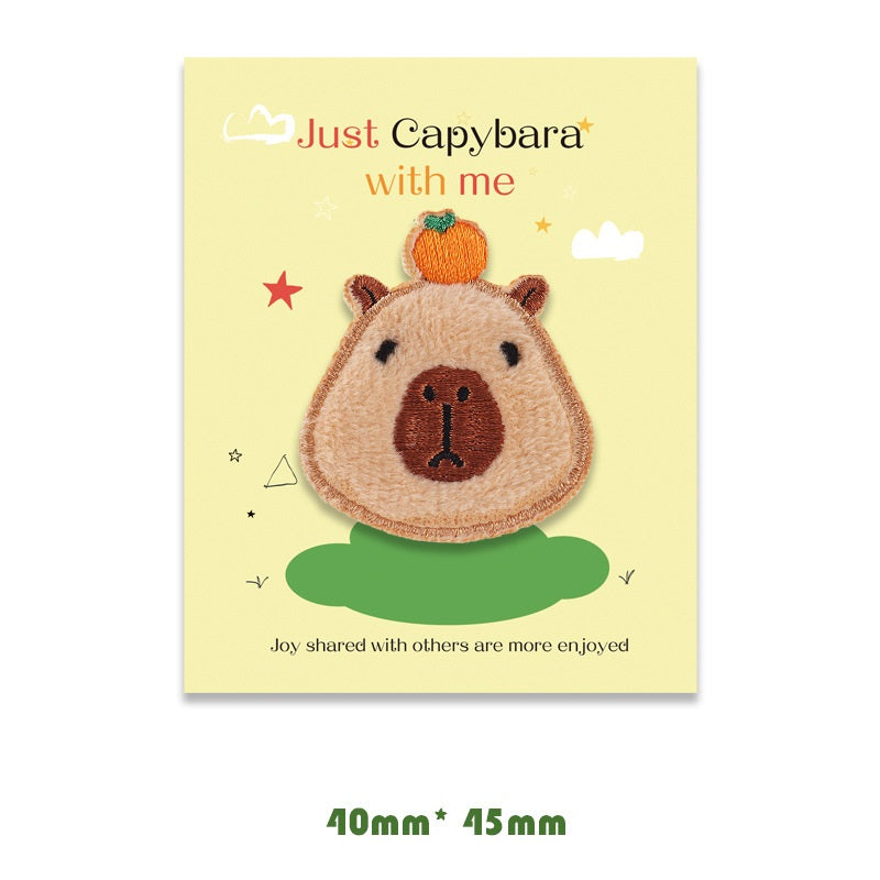 Brown and tan capybara embroidered self-adhesive patch, badge-style round head.