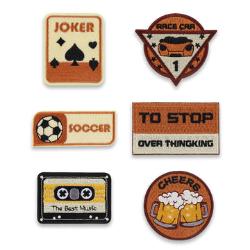 6-pack self-adhesive embroidered patches: Joker, race car, soccer, cheers, cassette, slogan.