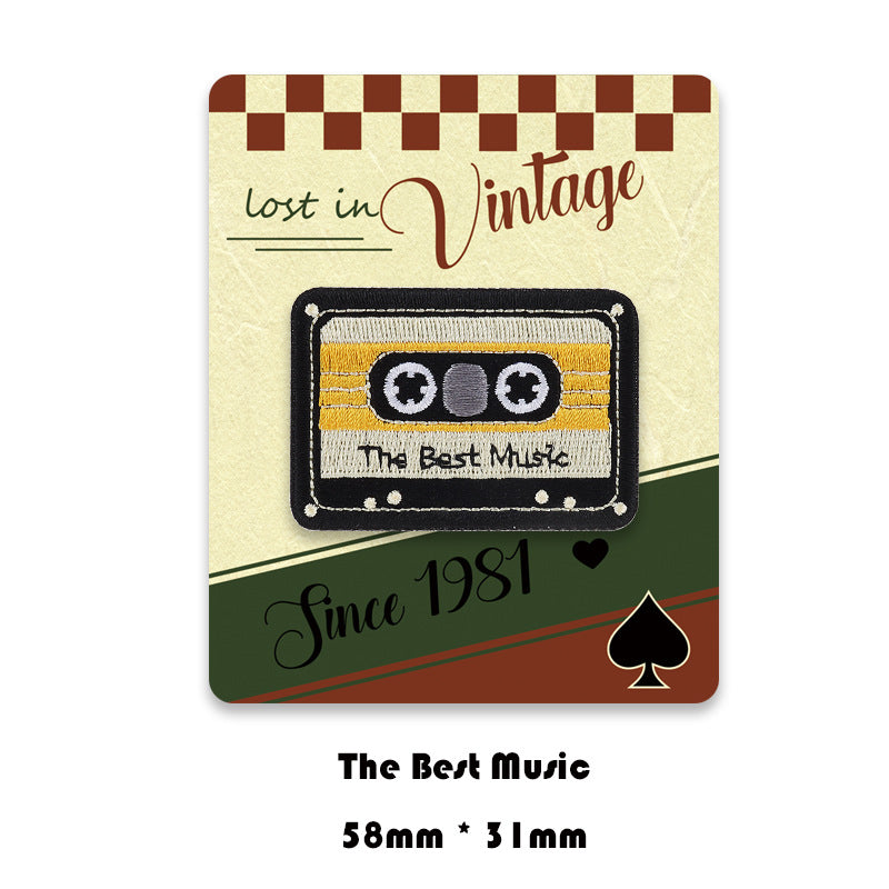 Black-and-yellow cassette embroidered patch with reels and 'The Best Music' text.