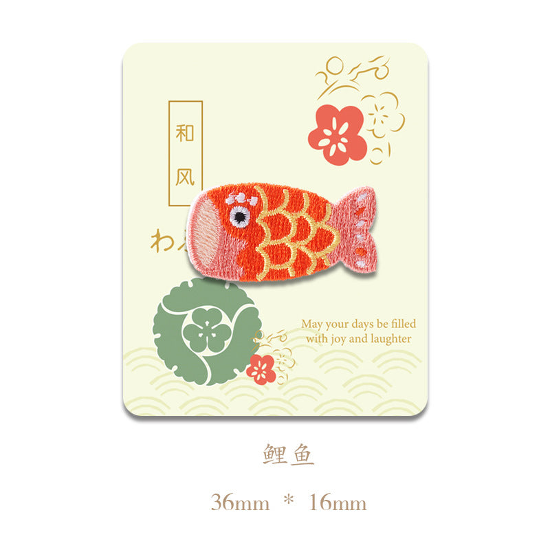 Orange koi-style fish embroidered patch with fins; 36mm x 16mm
