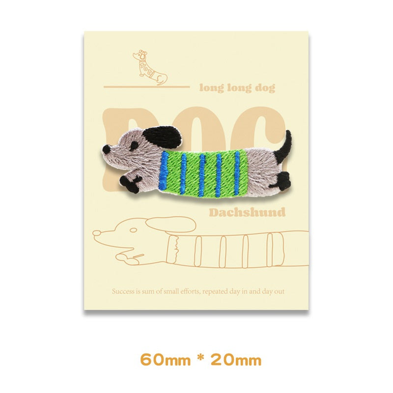 Embroidered dachshund patch, gray with blue-green striped belly, 60 x 20 mm