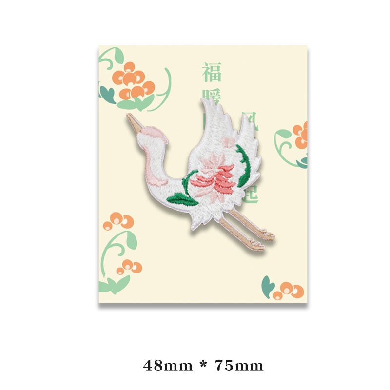 Embroidered white bird patch with pink flower and green leaves, self-adhesive backing