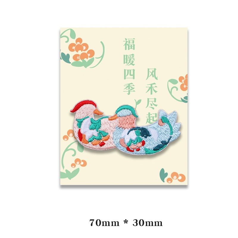 Embroidered blue fish patch with orange and red details, self-adhesive backing