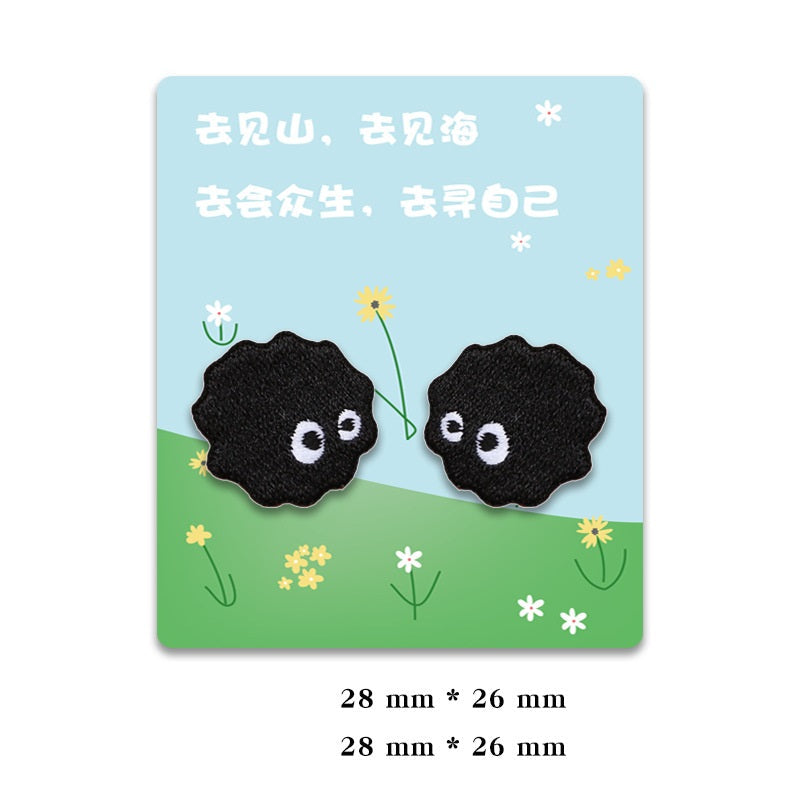 Two black self-adhesive coal ball elf patches with white-eyed faces
