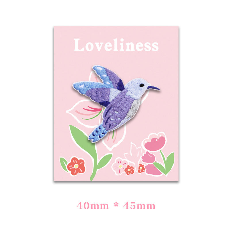 Self-adhesive hummingbird embroidered patch, purple-blue, 40 x 45 mm