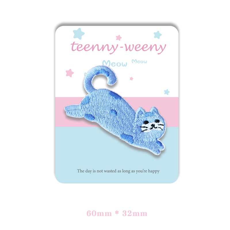 Light blue cat self-adhesive embroidered patch with rounded face and arched tail