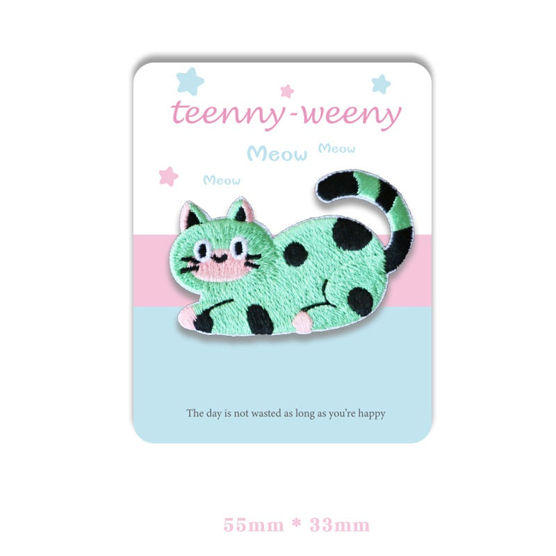 Green cat self-adhesive embroidered patch with black spots and curled tail