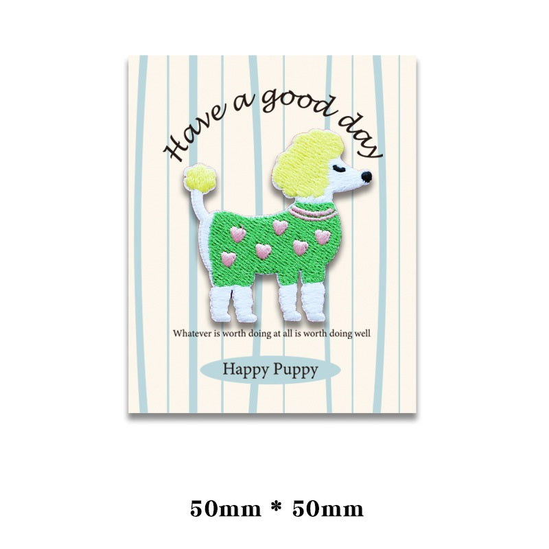 Embroidered dog patch: small dog in green heart sweater with light blue collar