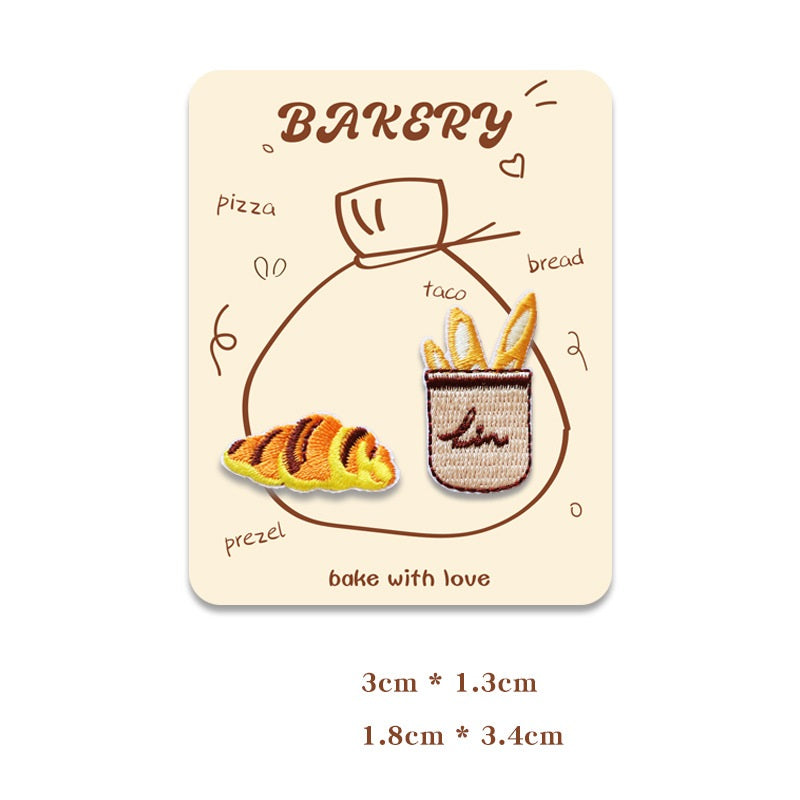 Card showing two mini embroidered baking patches: pretzel and baguette.