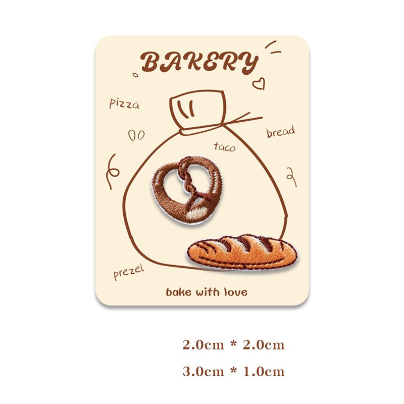 Card showing two mini embroidered baking patches: pretzel and sliced bread.