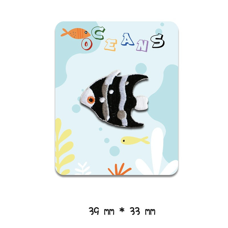 Black-and-white striped fish embroidered patch with orange eye, 39 mm x 33 mm, self-adhesive