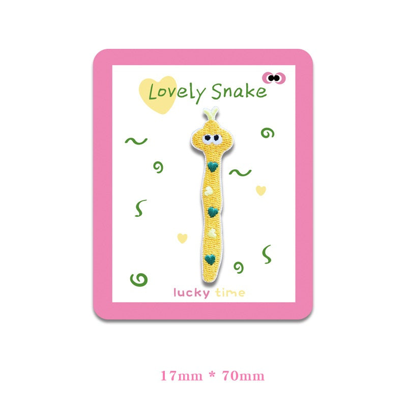 Yellow snake embroidered cloth patch with heart-shaped spots and big eyes