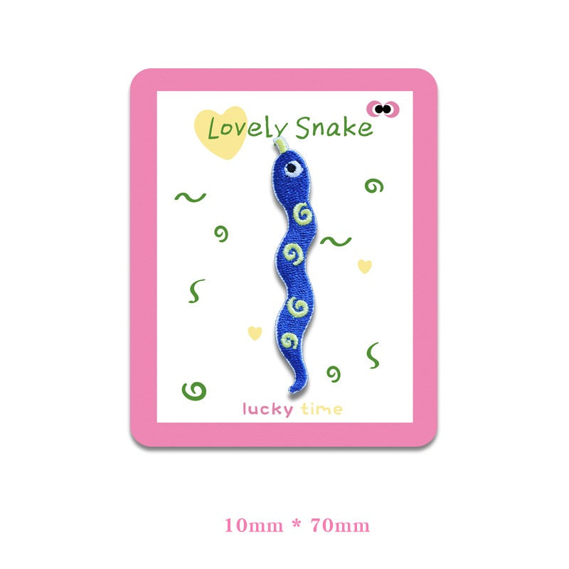 Blue snake embroidered cloth patch with spiral markings and big eyes