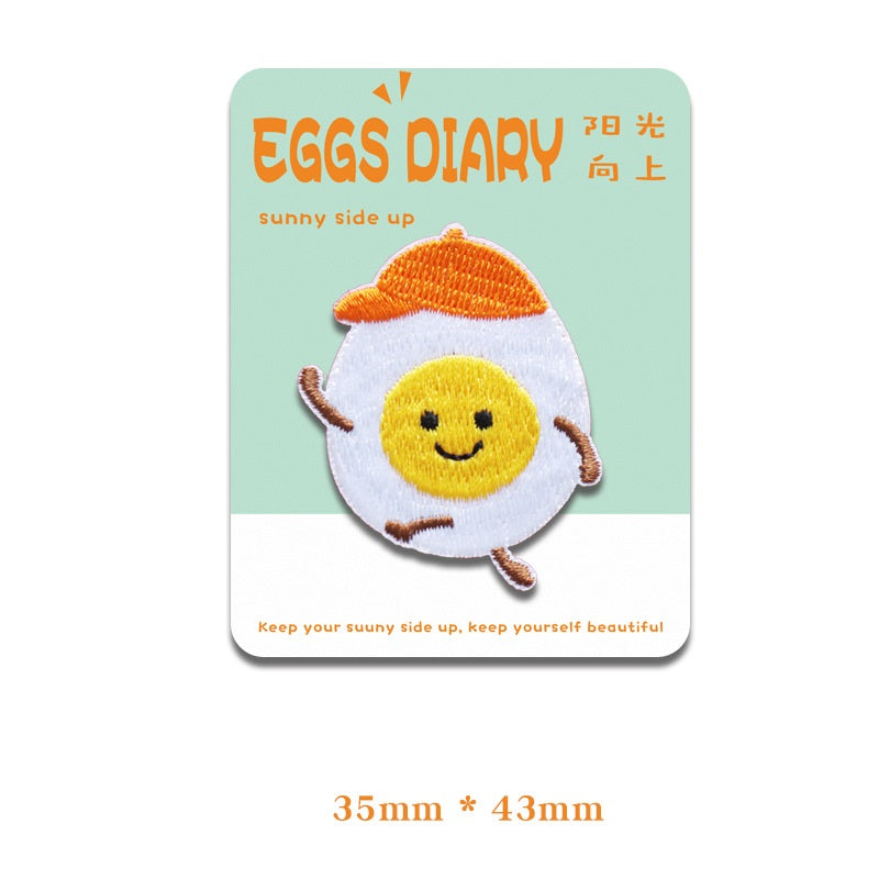 Smiling fried egg embroidered patch with orange yolk and raised arms