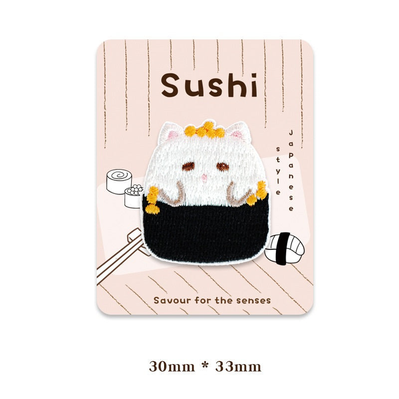 White cat sushi patch with yellow paws and a black seaweed bottom panel, stitched details