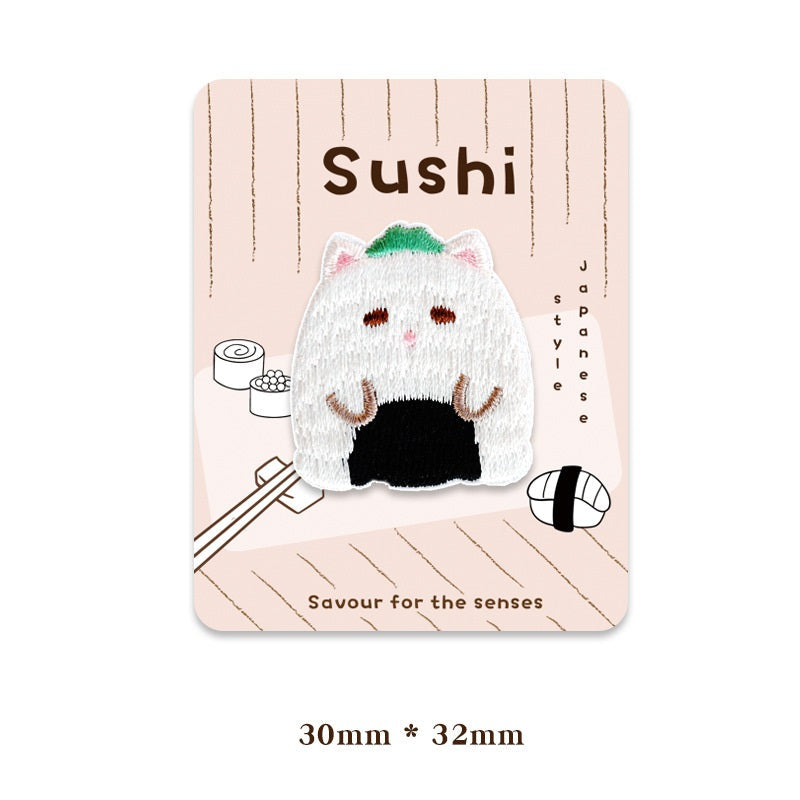 White cat sushi patch with green topping, small red mouth, and black bottom area