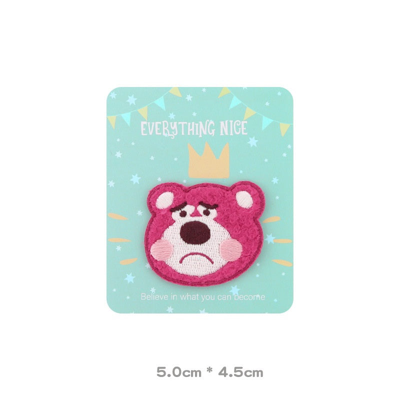 Pink embroidered bear head patch with worried/sad expression, white muzzle and pink ears