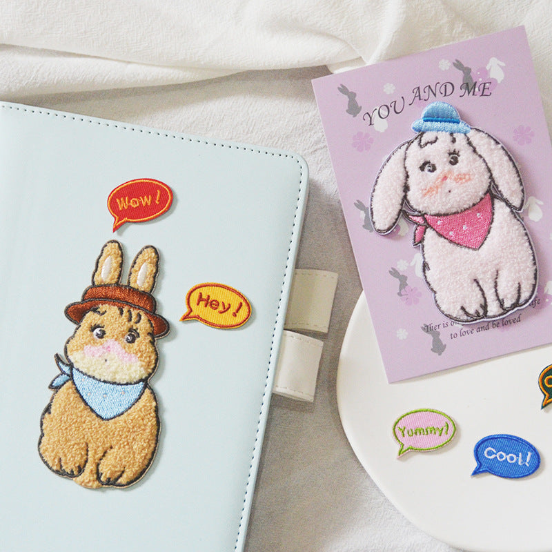 Self-adhesive towel rabbit patches on book cover: brown rabbit and blue-hat bunny