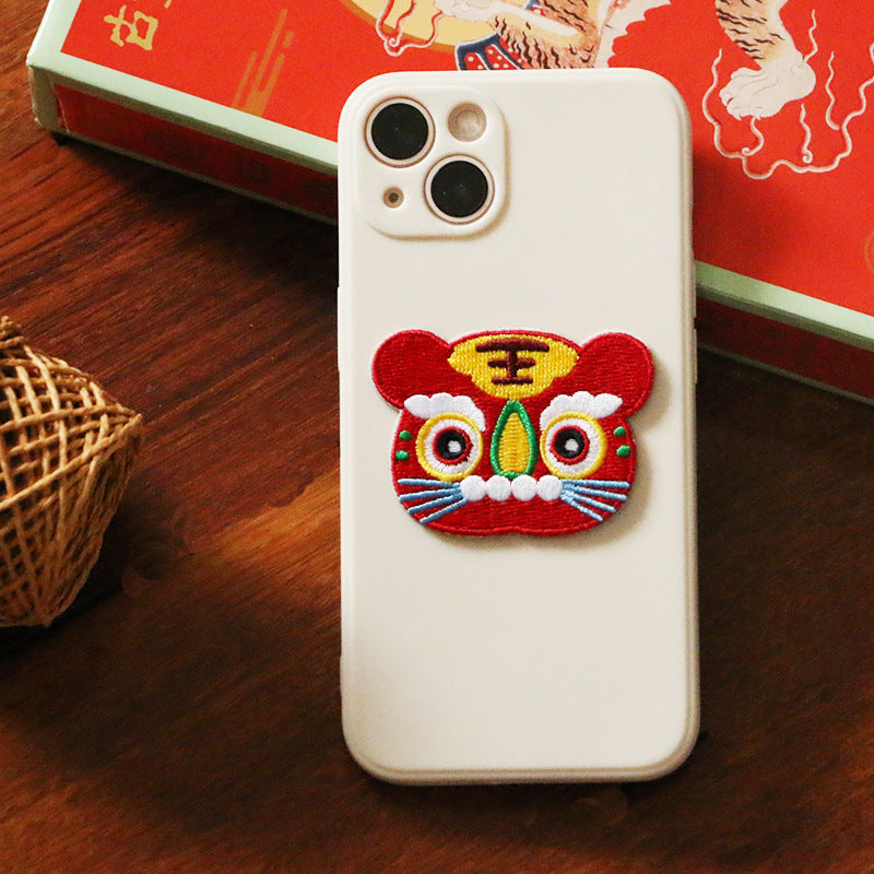 Red and multicolor embroidered tiger face patch, with yellow '王' character