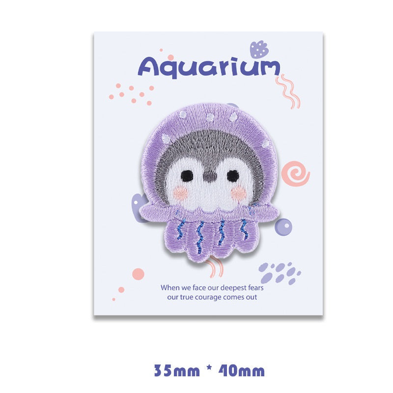 Purple jellyfish self-adhesive embroidered patch with gray face and blue tentacles