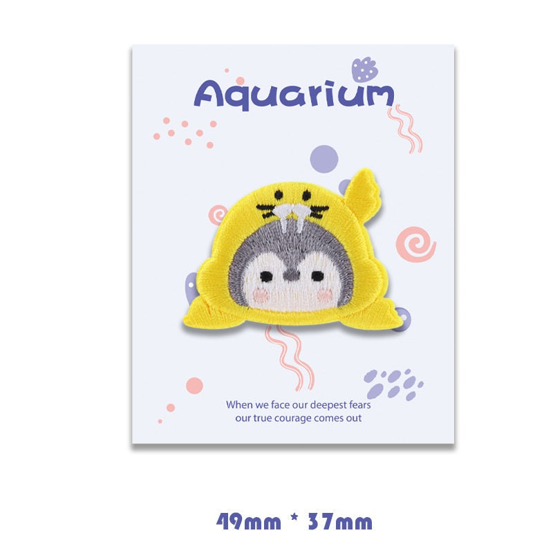 Yellow walrus self-adhesive embroidered patch with gray face and rounded flippers