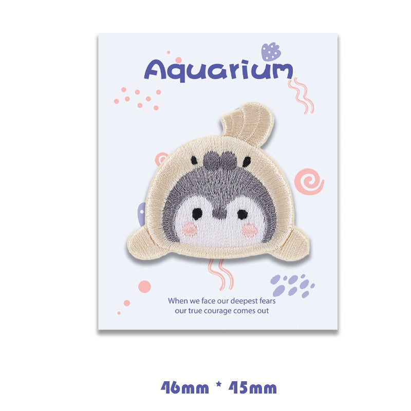 Beige seal self-adhesive embroidered patch with gray face and pink cheek details