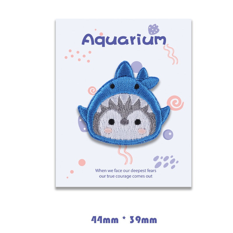 Light blue manta ray self-adhesive embroidered patch with gray face and small tail