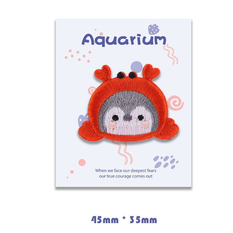 Red crab self-adhesive embroidered patch with gray face and orange pincers