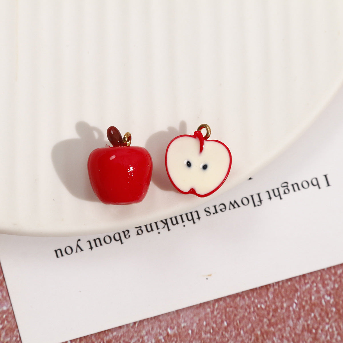 Red cartoon apple resin pendants: one whole apple and one cut half with face details