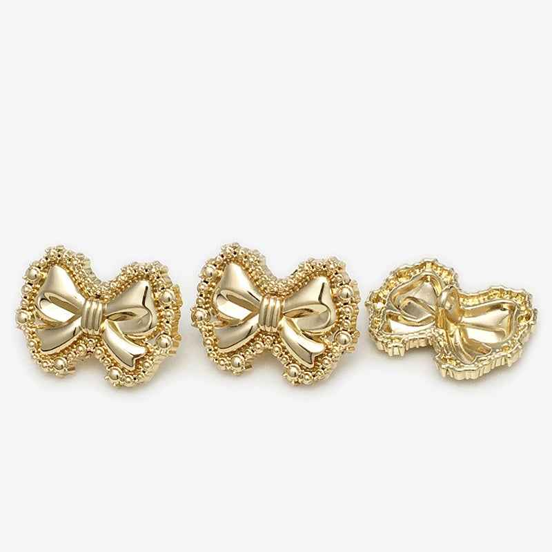Gold bow metal shank buttons, front view (three)