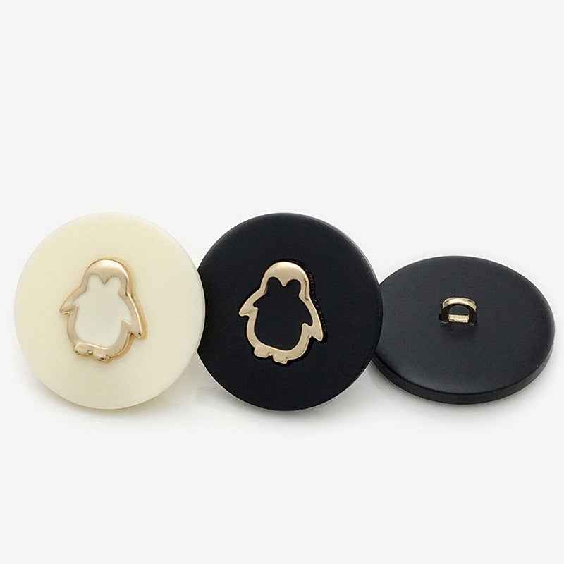 Beige and black resin shank buttons; black back shows loop