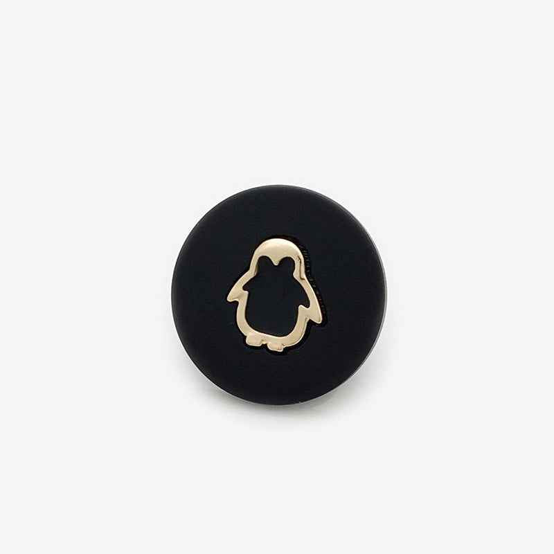 Black resin shank button with gold penguin outline