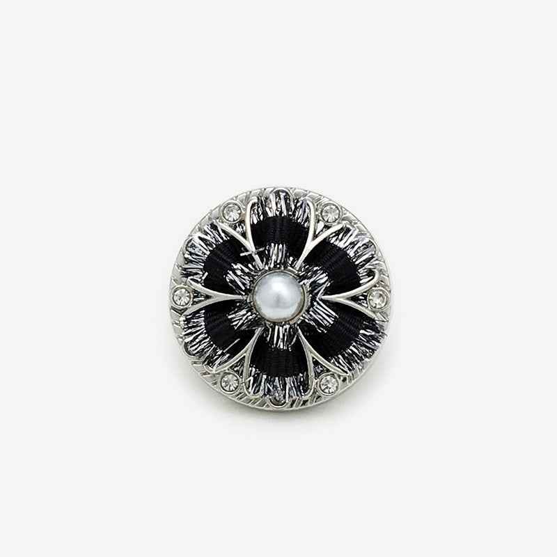 Black hand-knitted floral shank button in silver tone, pearl center and rhinestones